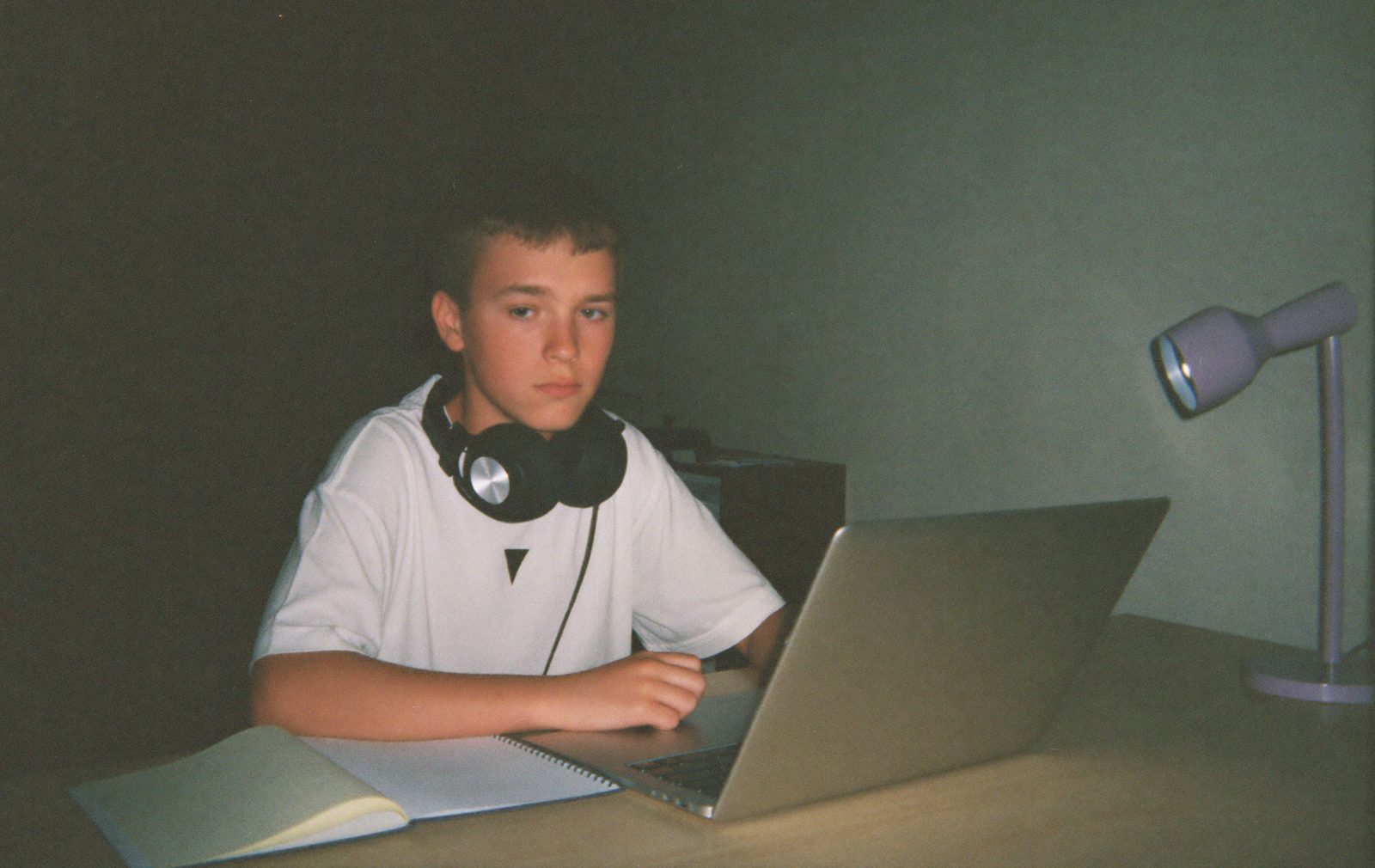 A student working at a desk at night